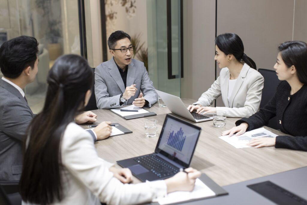 Family members and advisers discussing wealth governance and long-term planning in a professional meeting.