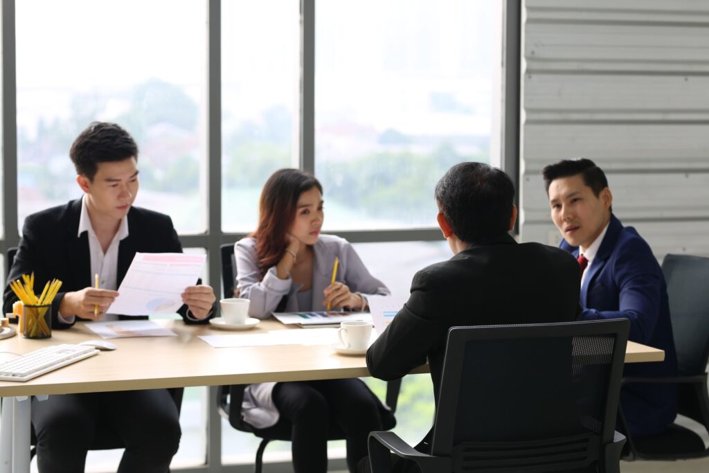 Family members meeting with professional advisers to discuss wealth governance and succession planning.