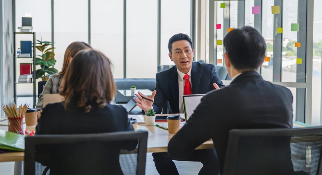 Single family office team discussing investment strategy and fund management requirements in Singapore.